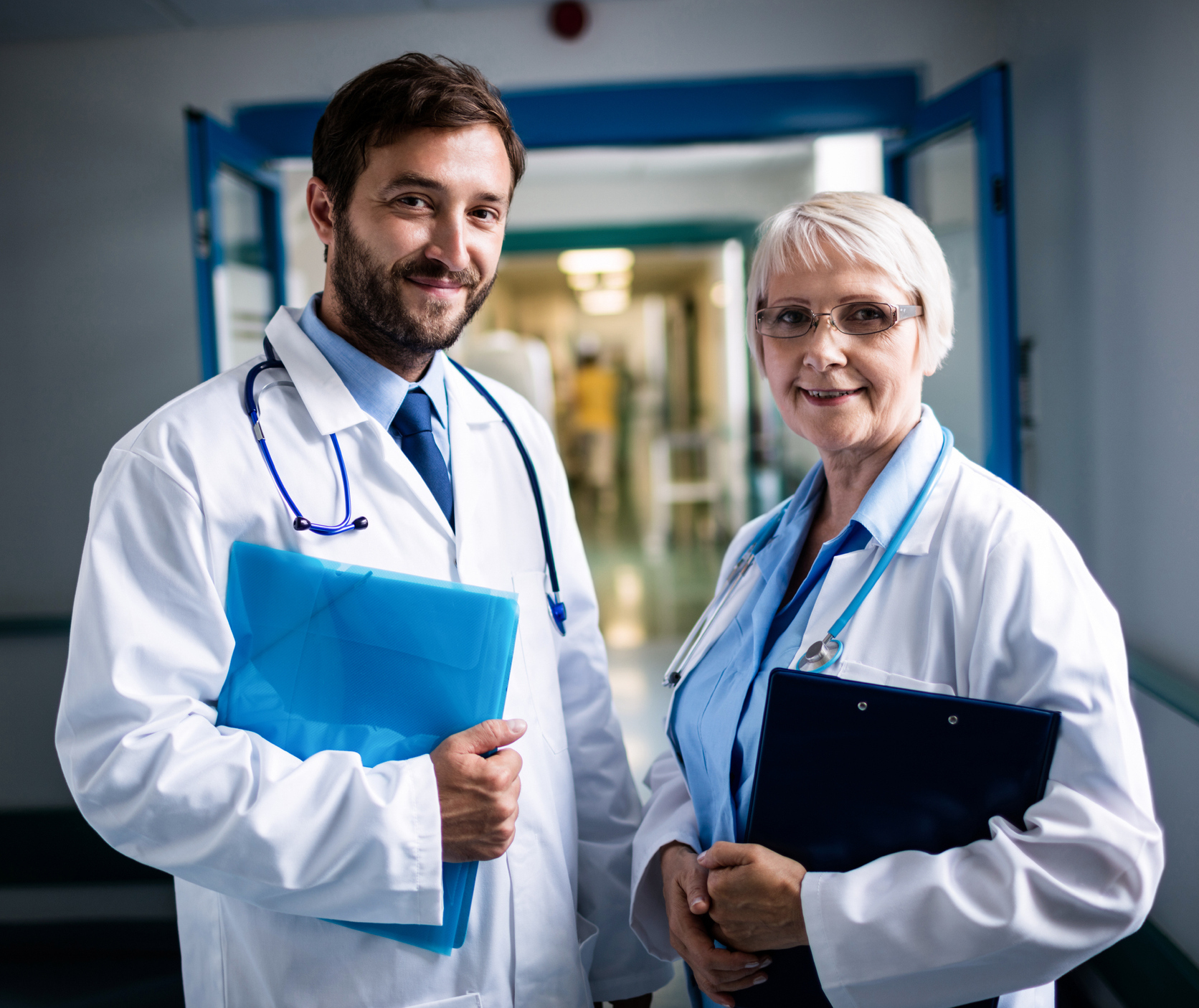 Doctors standing together with clipboard and file